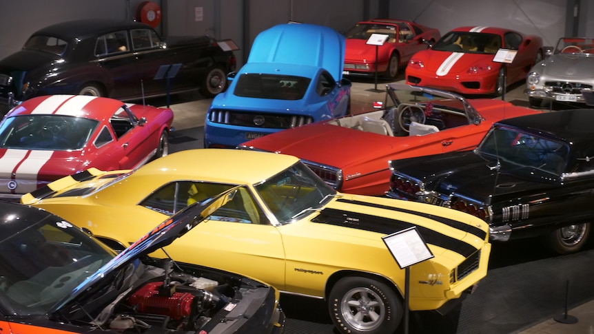 A range of old cars in a car museum.