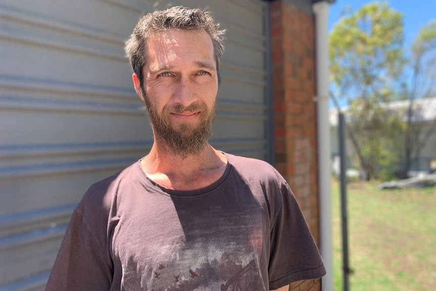 Rosewood local Paul Taylor stands in front of his garage at his home, west of Ipswich.