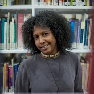 Sue Mcpherson standing in a library.