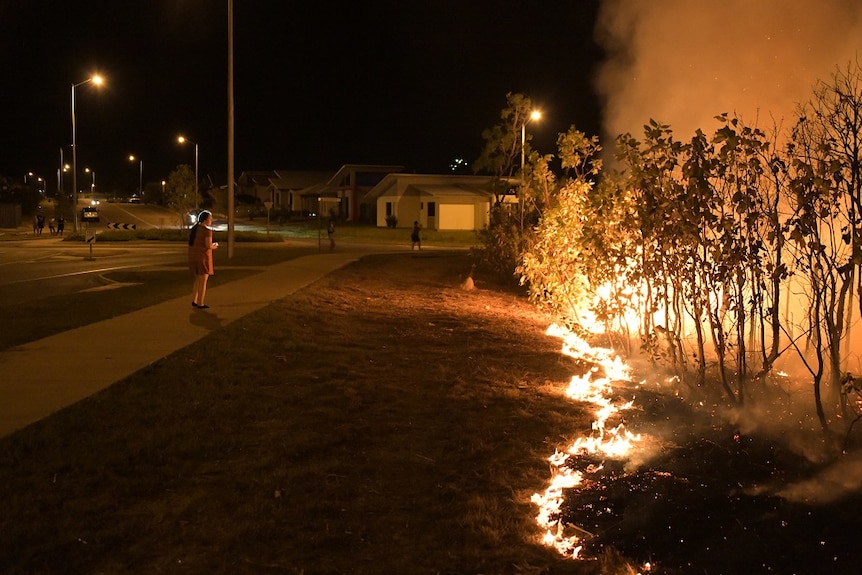 A fire burns by the side of the road in Zuccoli.