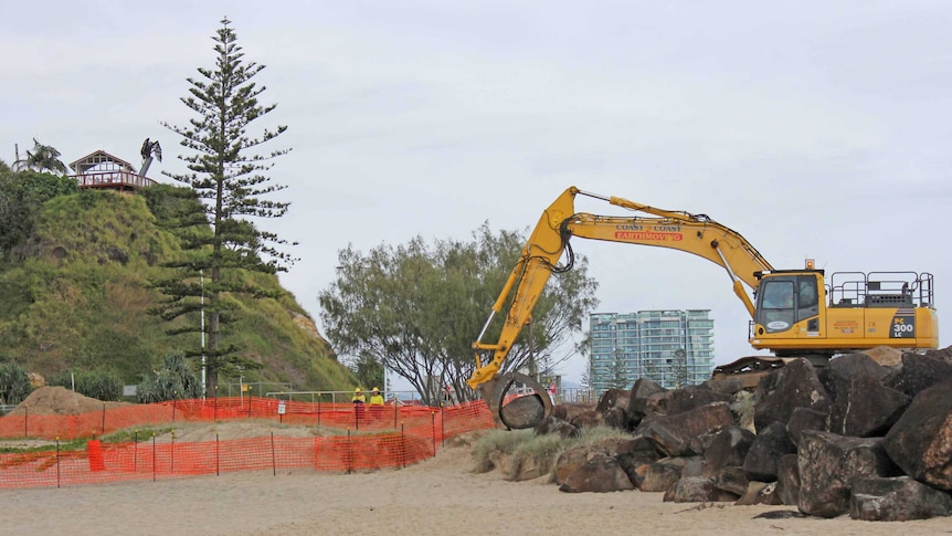 A bulldozer works on the extension of the groyne at Kirra Point on the Gold Coast