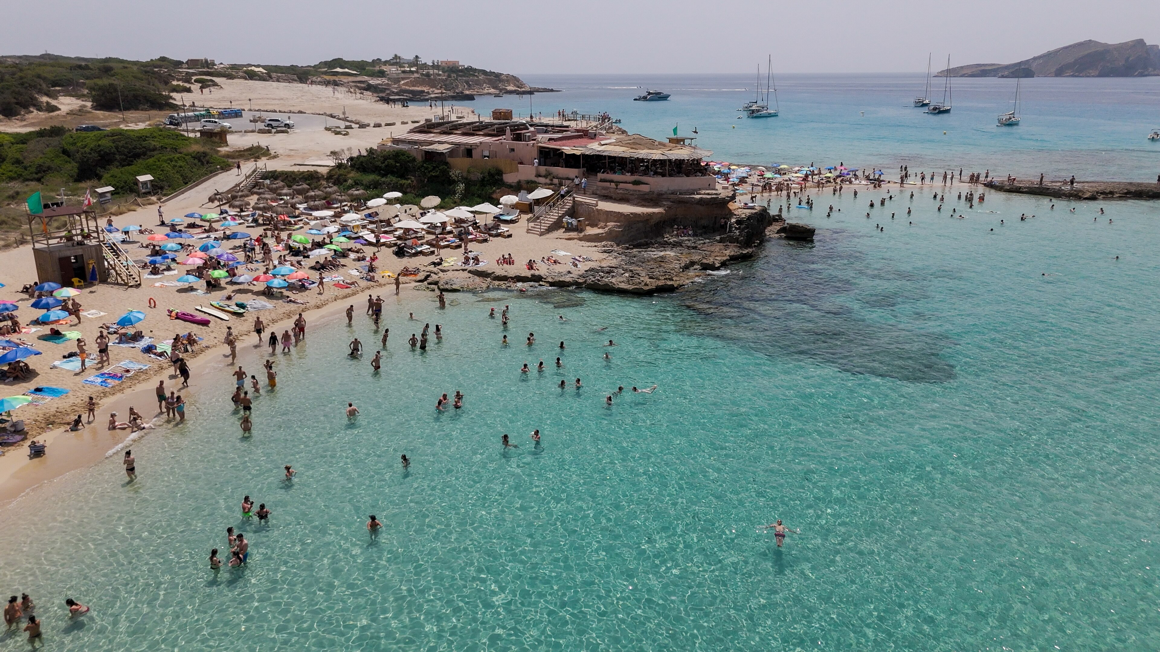 A beach with people swimming.