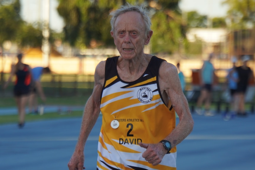An elderly, yet muscular, gentleman running.
