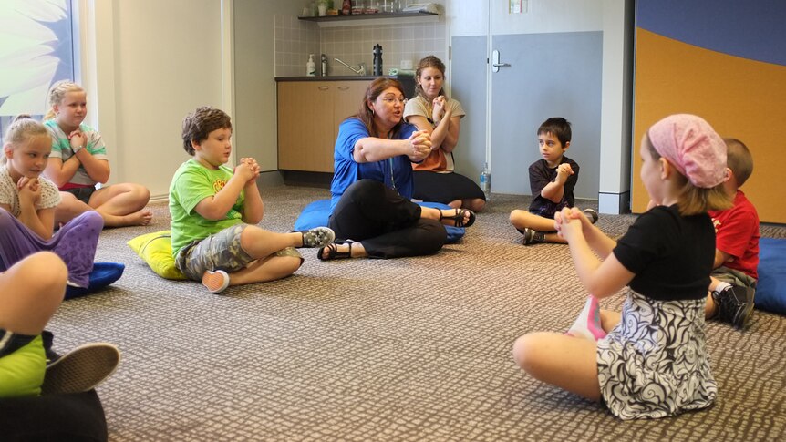 Shery Batchelor takes some children through a mindfulness exercise.