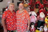 Two men in red Hawaiian shirts standing in a Christmas shop