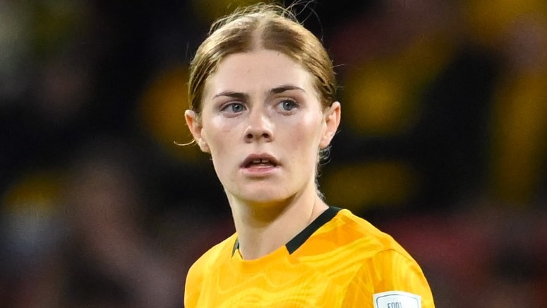 A close up of Cortnee looking serious on the pitch.