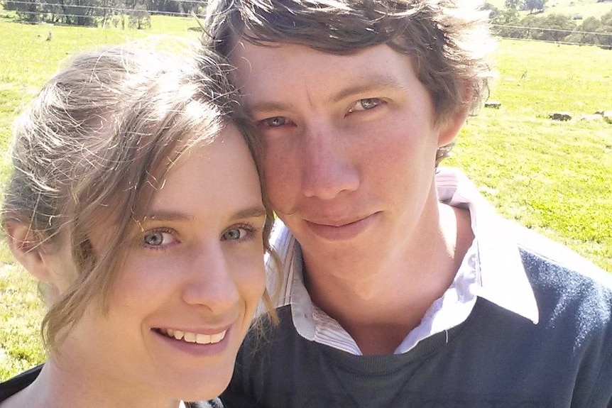 a young couple smiling at the camera