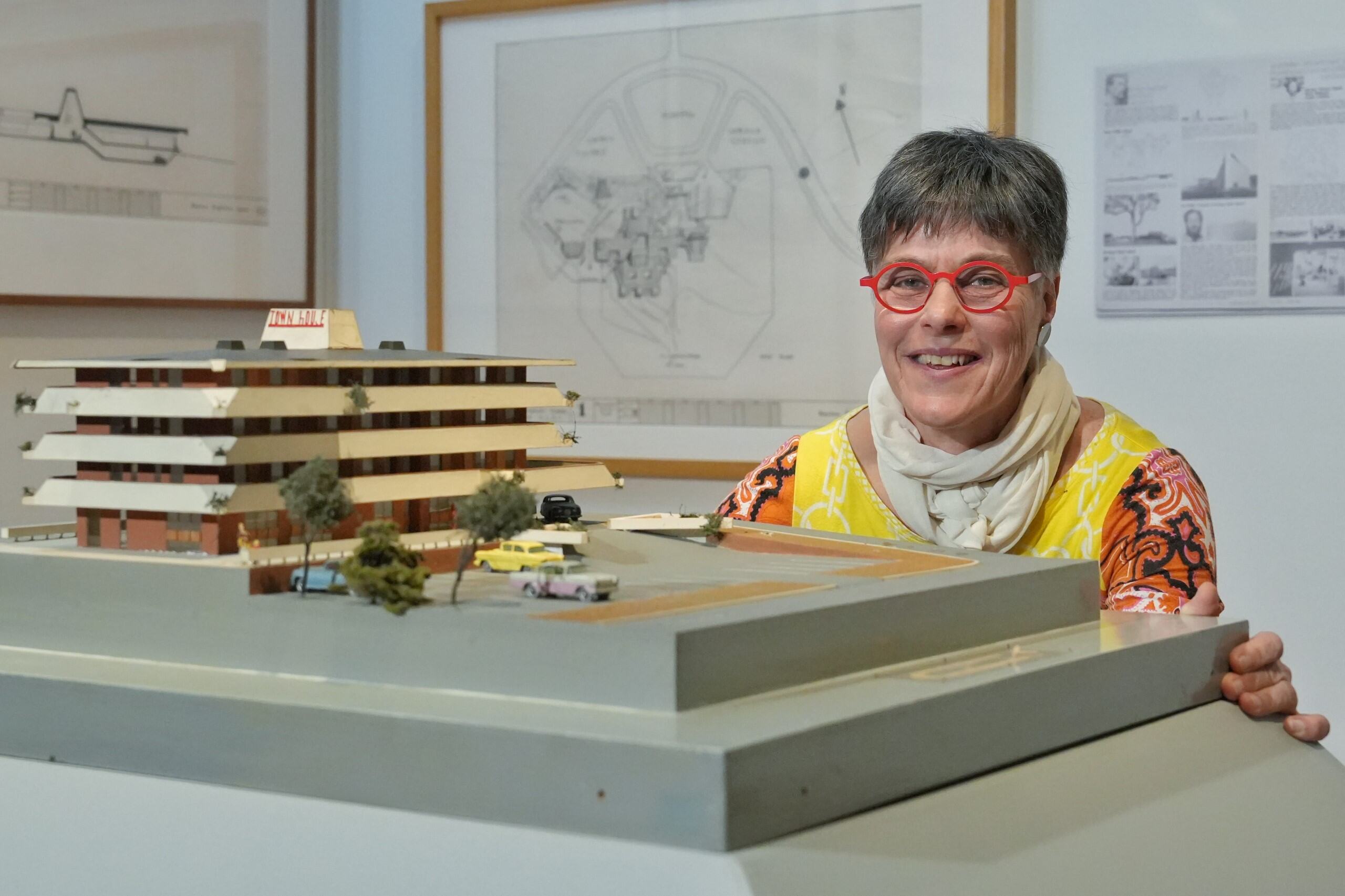 Tanja Taglietti ⁣standing by an architectural ​model at​ the exhibition