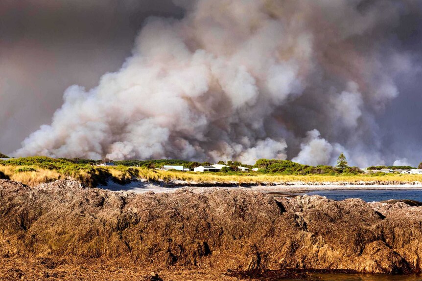 Smoke covers the coastal settlement of Windy Harbour during bushfires at Northcliffe.
