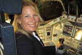 Kim Ellis Hayes sitting in the captain’s seat of the NASA’s Space Shuttle Endeavour