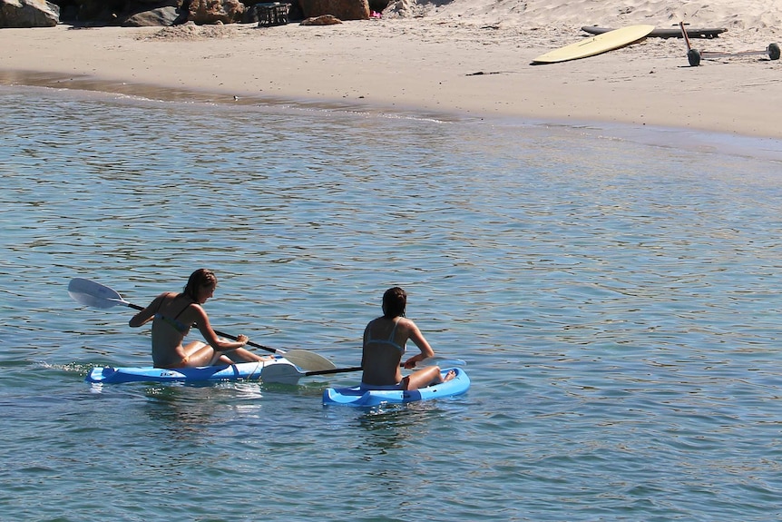 Two girls on surfskis at West Beach