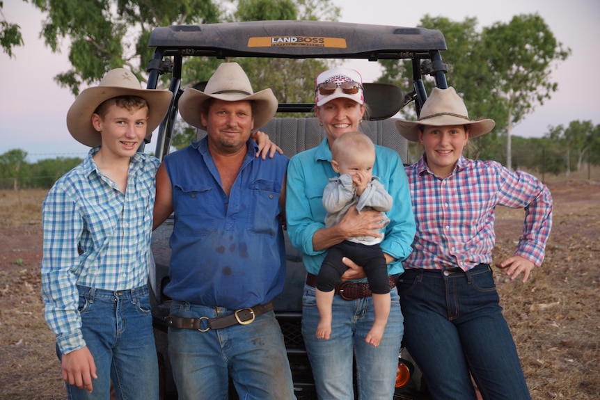 Photo of the Phillips and Fisher family in front of their car