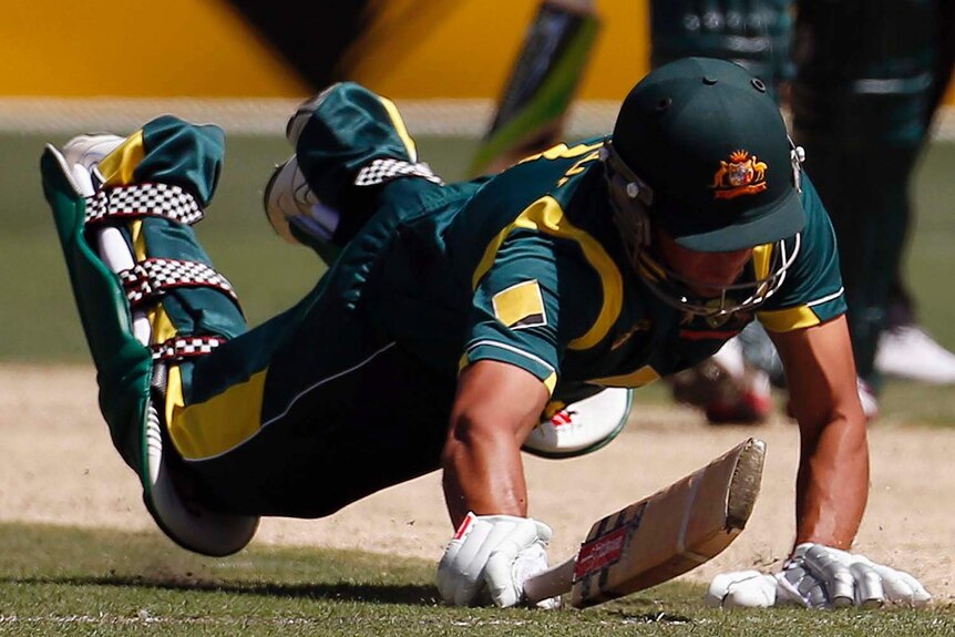 Australia's Usman Khawaja's bat is run out against Sri Lanka at the MCG.