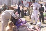 People in Pakistan await aid following the devastating earthquake that has claimed over 20,000 lives.
