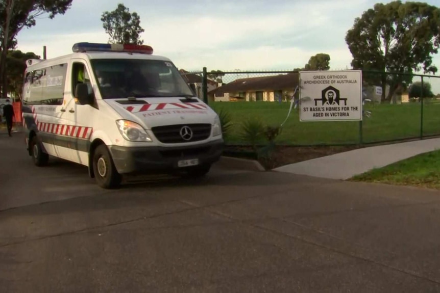An ambulance pulls out of the driveway of St Basil's aged care home.
