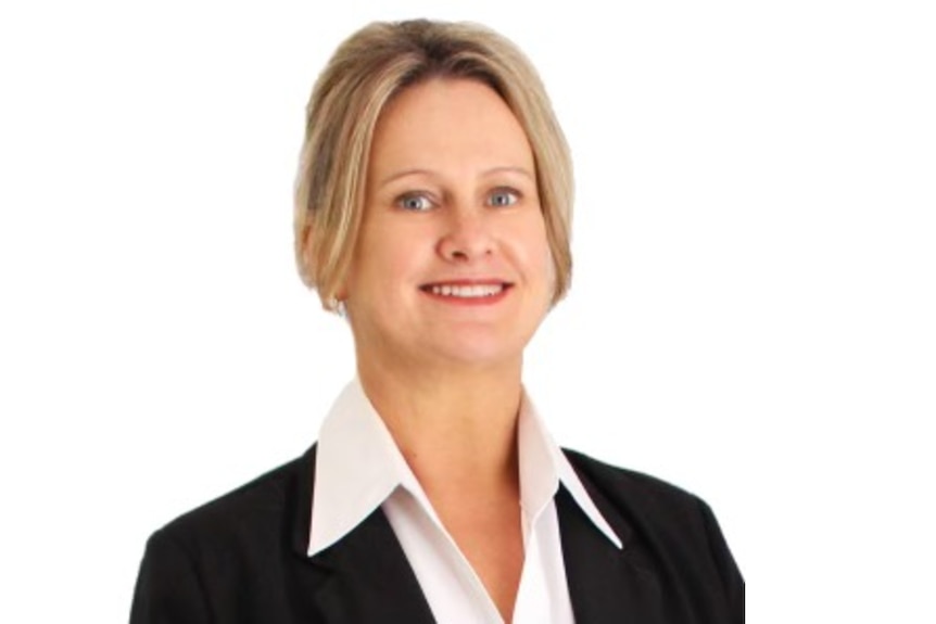 A headshot of a female real estate agent