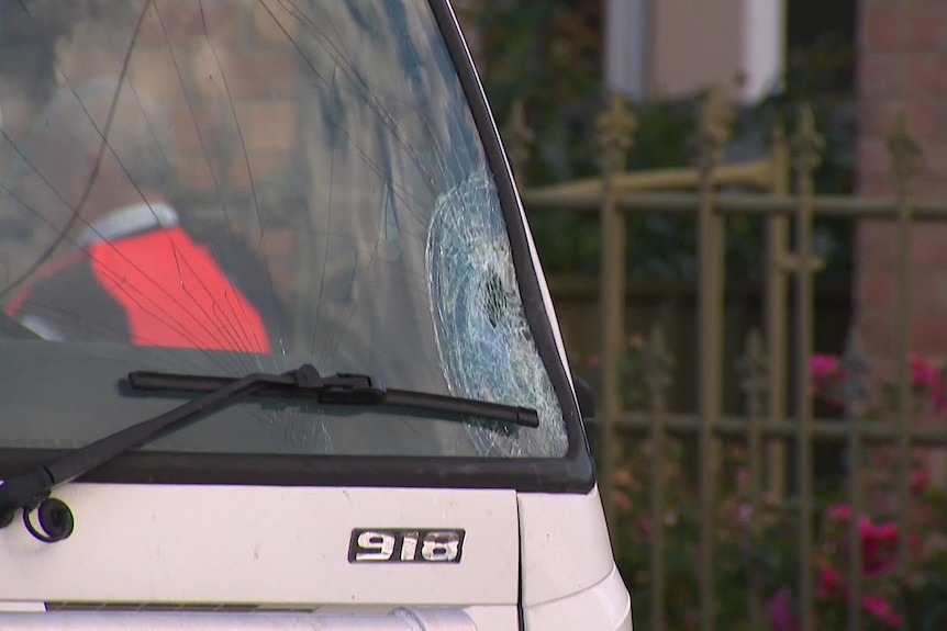 A mid-shot of the smashed corner of the windscreen of the truck involved in the crash.