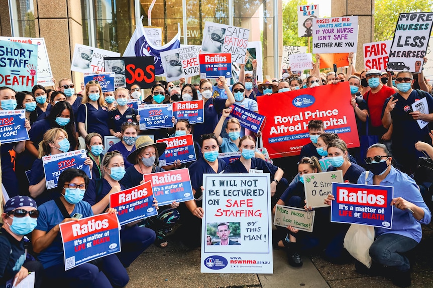 Protesting nurses holding signs