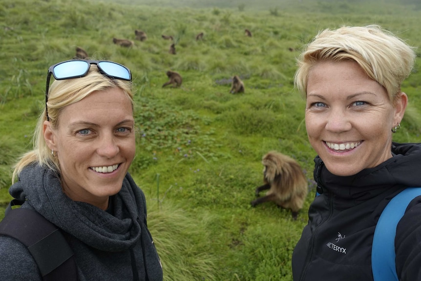 Martina and Rachel take a selfie photo in front of monkeys in Ethiopia