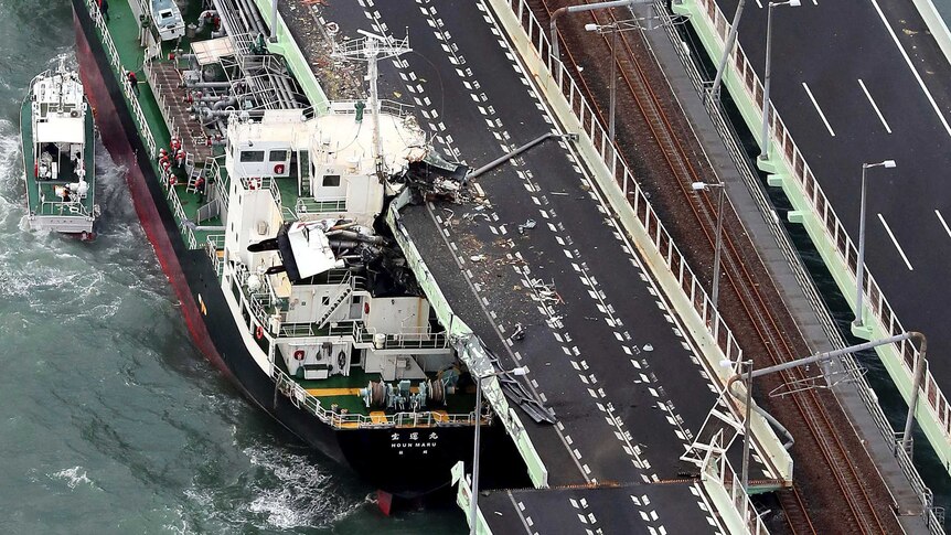 A tanker is seen after it slammed into the side of a bridge connecting the airport to the mainland