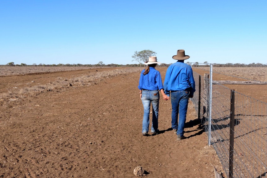 Clare and David Paterson examine their drought-ravaged property near Longreach