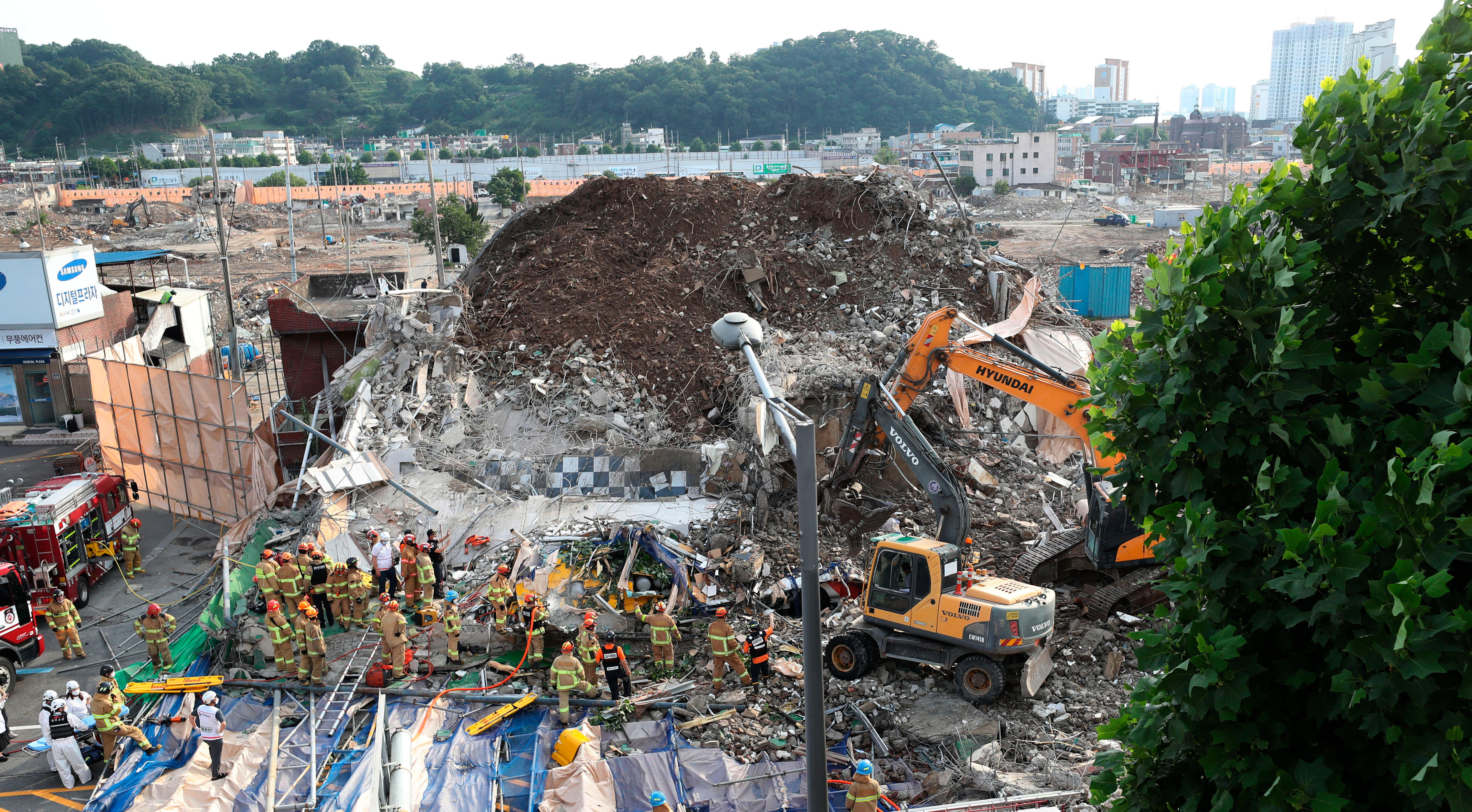 Firefighters search for survivors following a collapsed building in Gwangju, South Korea