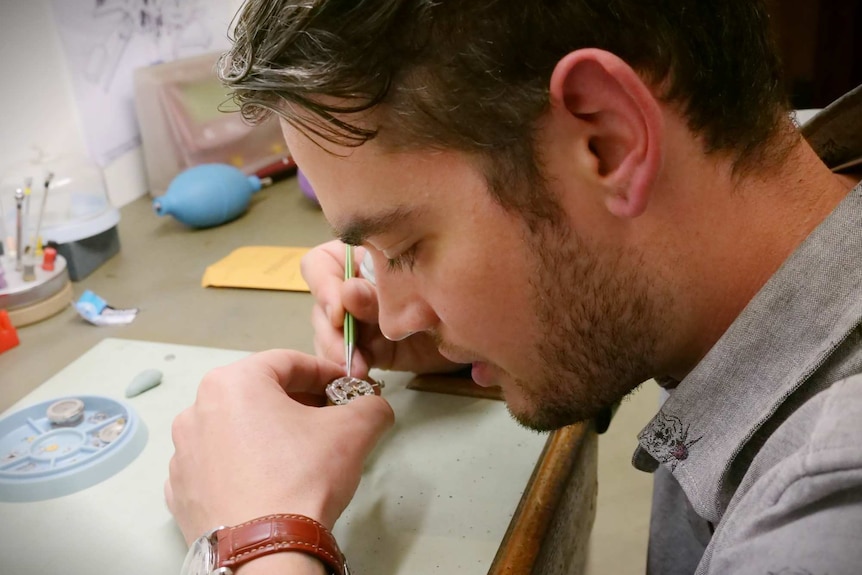 Tim Stewart repairs a watch