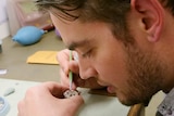 Tim Stewart repairs a watch