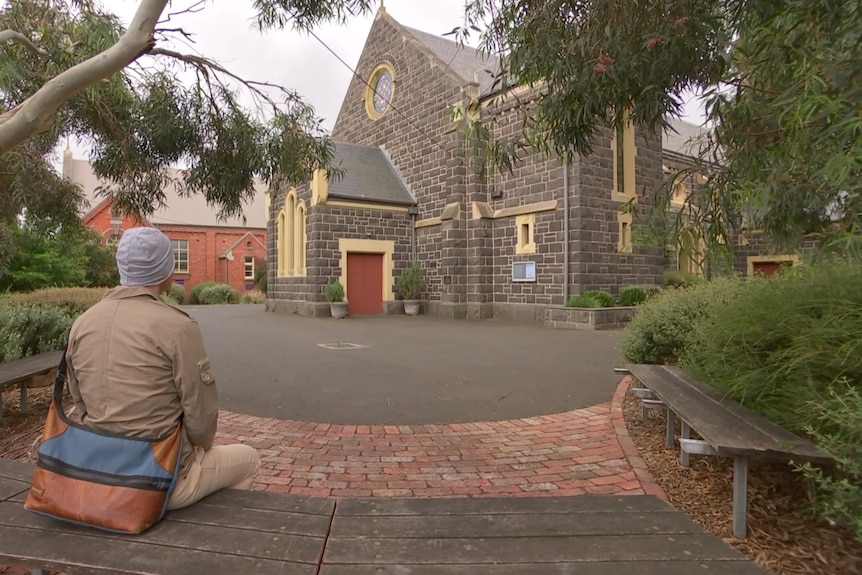 Adrian Ristau from behind looking at a church