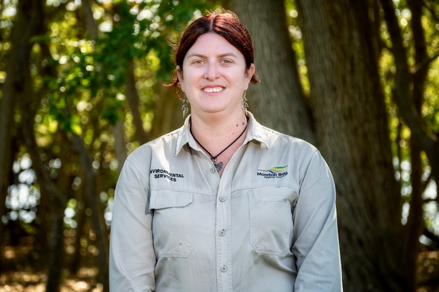 Jessica Gorreng,  Moreton Bay City Council Environment Team leader, stands in front of trees looking at camera