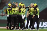 Australian women's cricketers high five after a wicket in the T20 World Cup semi-final.