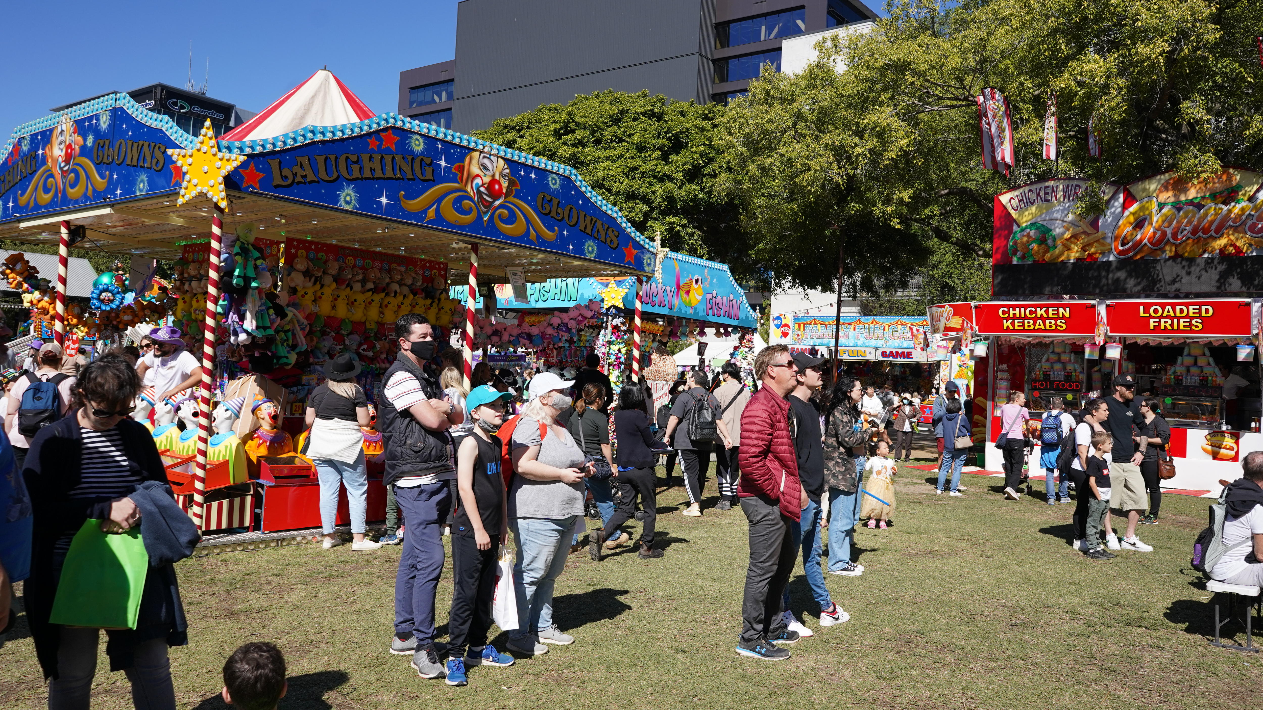 People stand in front of toys at a show.