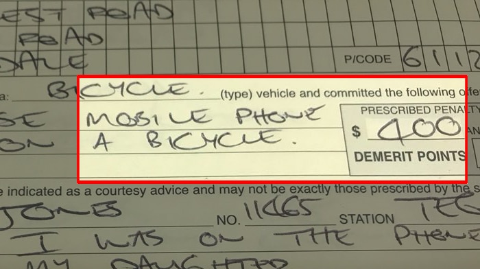A photo of a hand-written traffic fine showing a $400 penalty highlighted.