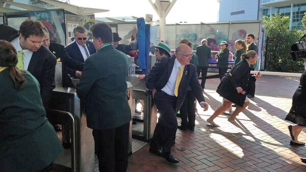 Melbourne Cup punters storm through the barriers to grab the best spot at Flemington.