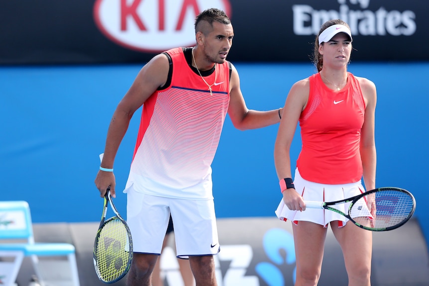 Nick Kyrgios puts his arm on Ajla Tomljanovic as they play mixed doubles in the Australian Open in 2016