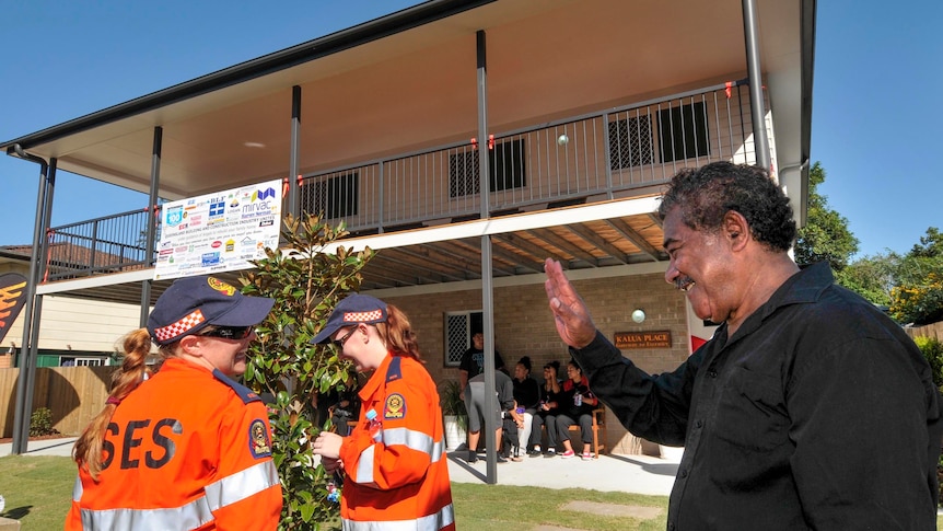 Tau Taufa farewells SES volunteers at the opening of a rebuilt home at Logan.