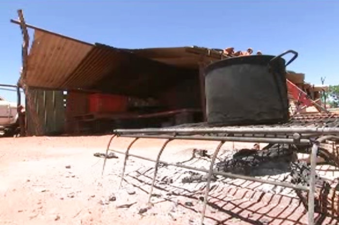 A corrugated iron shelter and makeshift cooking facilities at Arlparra community, NT.
