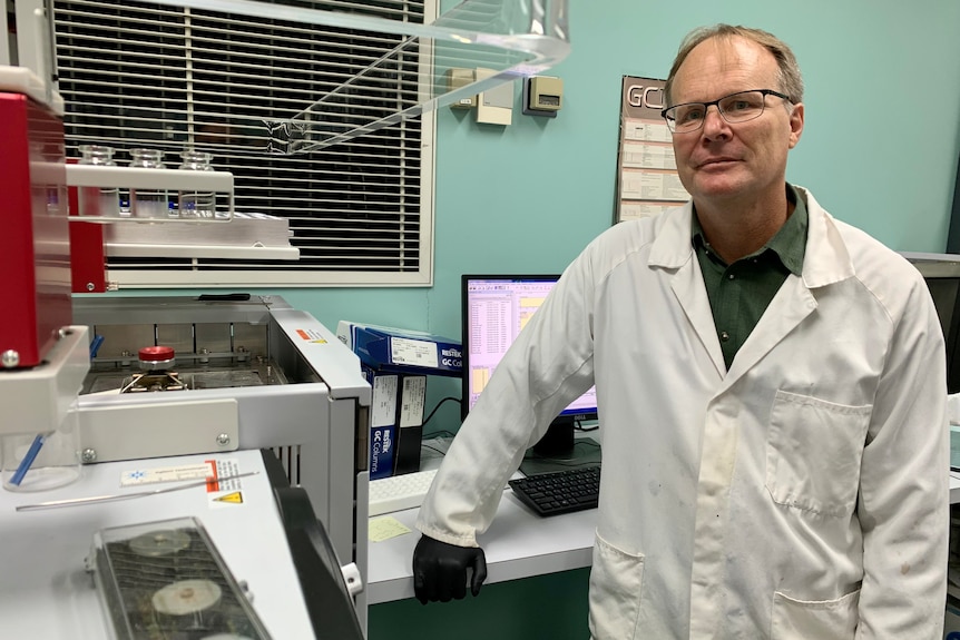 David Pass stands near technical equipment at Queensland Health's Forensic and Scientific Services lab