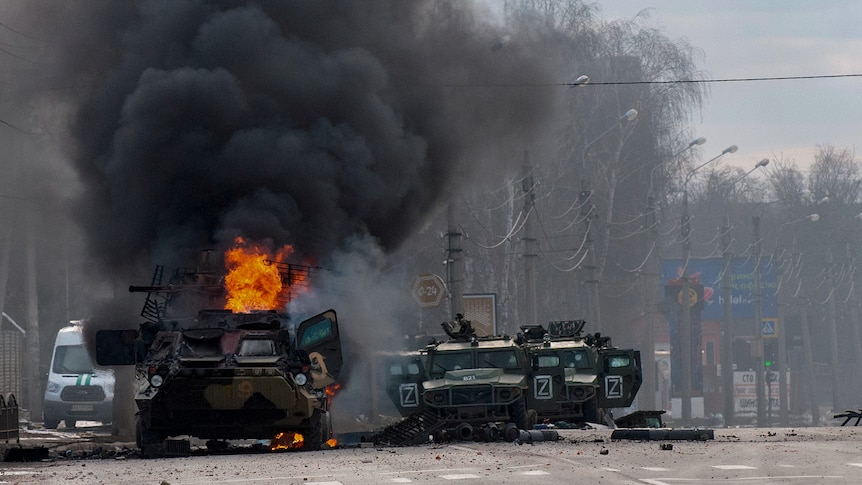 A Russian armoured personnel carrier in flames on the streets of Kharkiv, Ukraine.