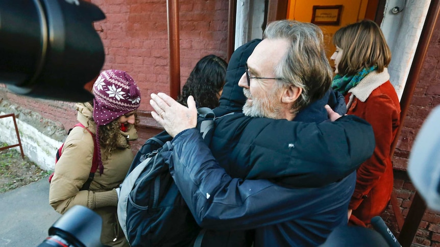 Colin Russell is greeted as he is released on bail from prison