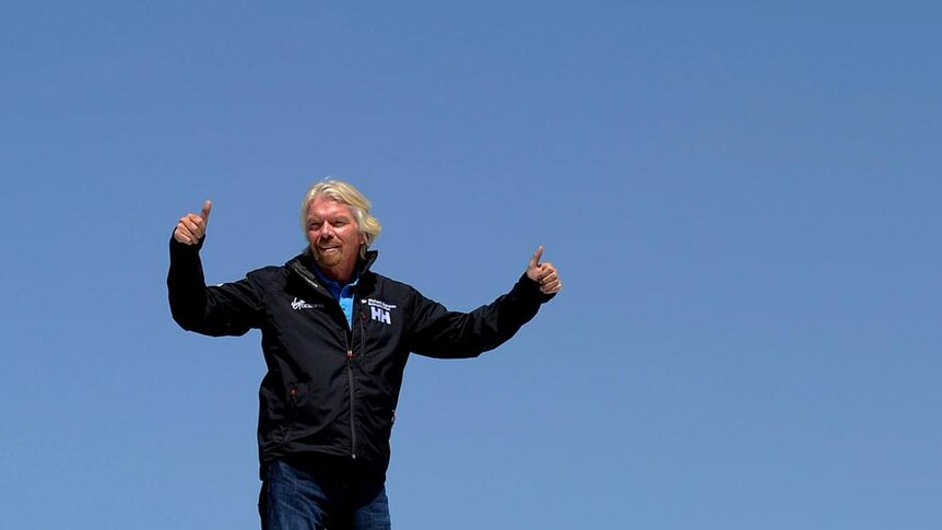 Sir Richard Branson stands on top of the Virgin Oceanic, a solo piloted submarine