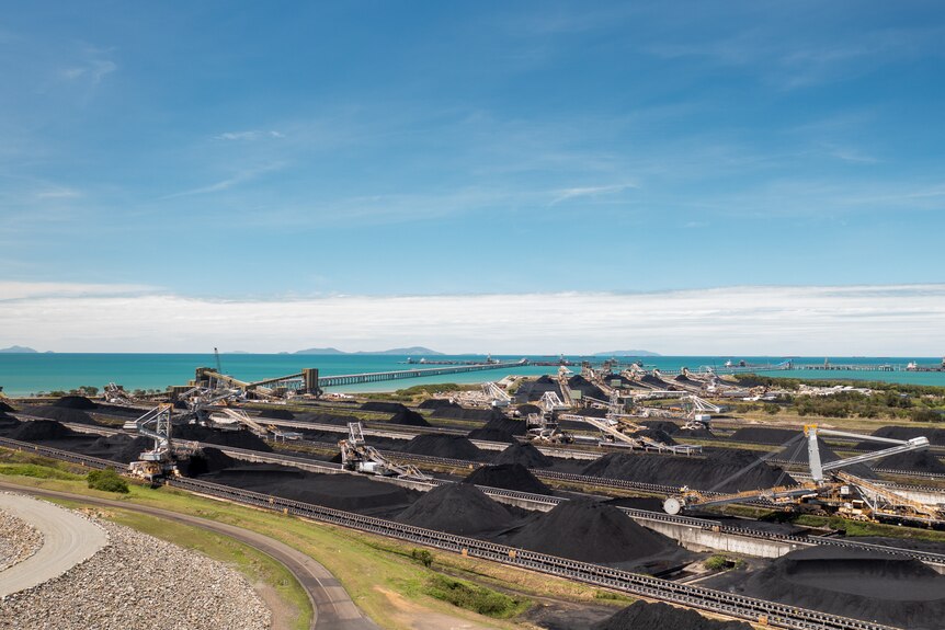 Aerial photo of Port of Hay Point, huge piles of coal are loaded and transported to ships, November 2021.