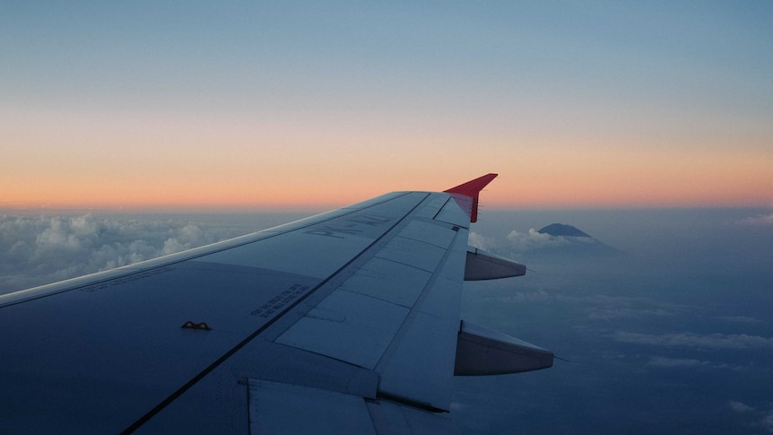 A plane's wing over clouds.