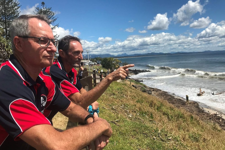 Byron Bay surf lifesavers Greg Clark (left) and Paul Pattison (right) survey the damage done by recent erosion at main beach.