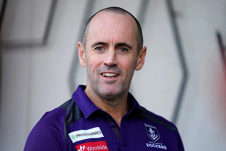 Simon Garlick wearing his purple Fremantle Dockers polo shirt