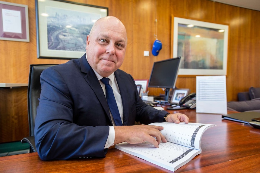 Victorian Treasurer Tim Pallas at his desk.