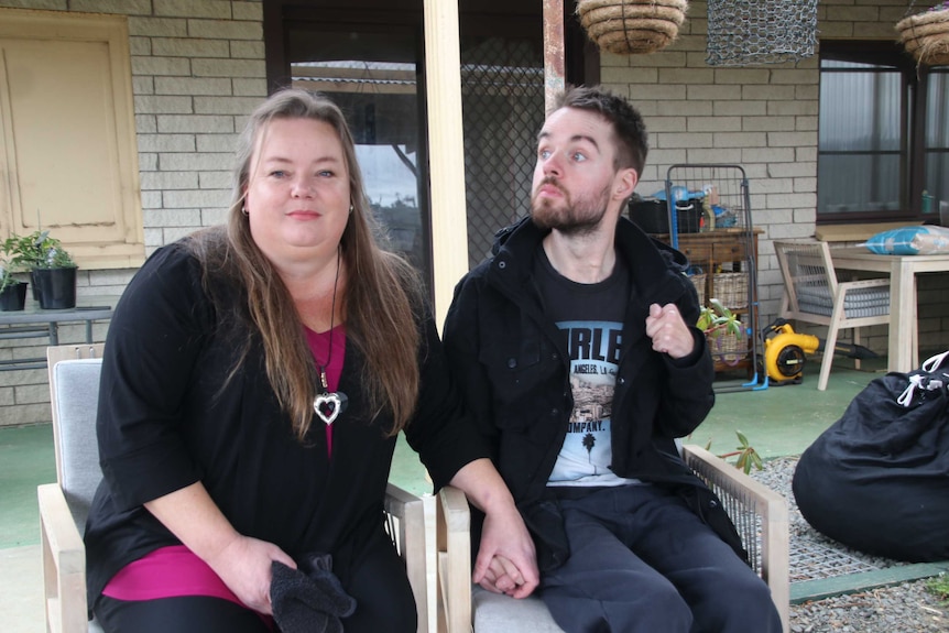 Lyn Cleaver and son Jeremy sitting outside their house