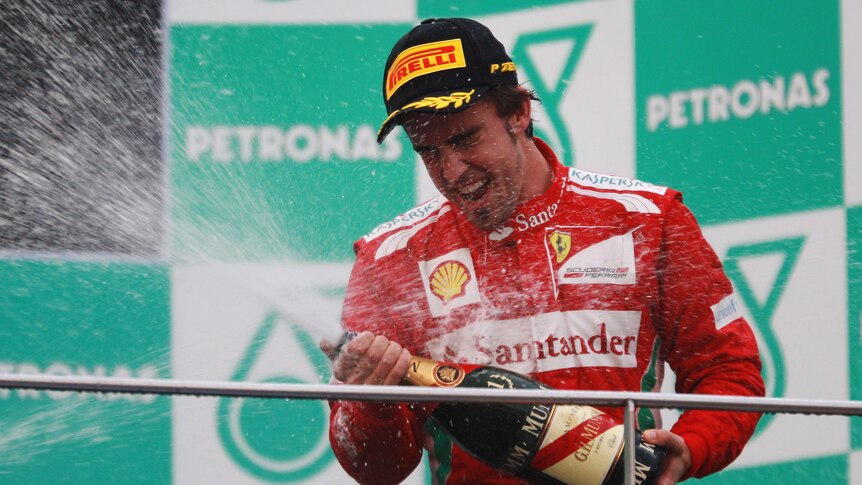 Winning in the wet ... Alonso celebrates his first F1 victory in eight months at Sepang.