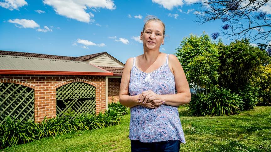 A woman out the front of a house