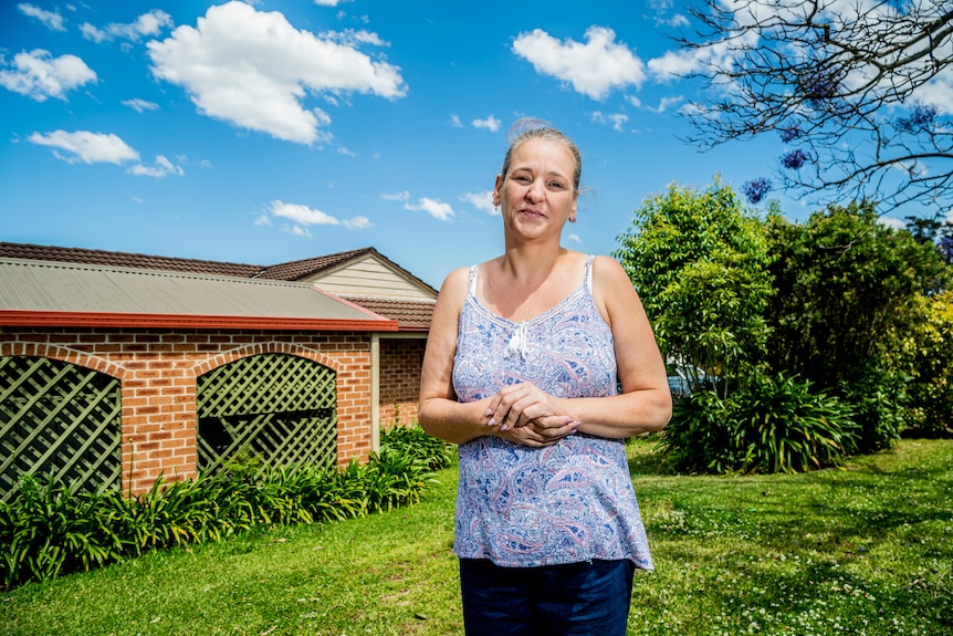 A woman out the front of a house